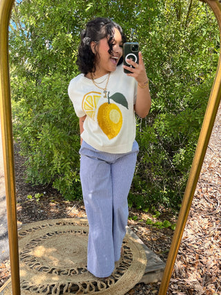 Blue striped wide leg pants with elastic waist paired with lemon graphic knit sweater.
