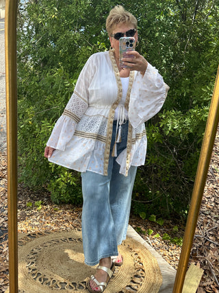 Ivory parasail shell kimono with lace panels and gold trim, worn open over white tank and light blue jeans.
