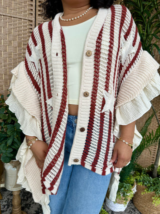 Cream and burgundy striped knit cardigan with button front and ruffle hem details.
