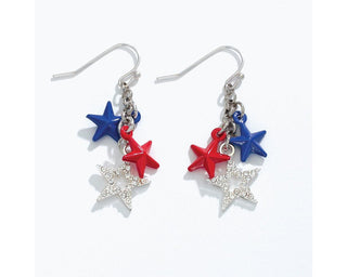 Silver hook earrings with red, blue, and crystal star charms clustered together.

