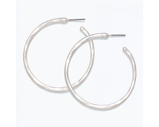 Silver matte hoop earrings with hammered texture and post backs.

