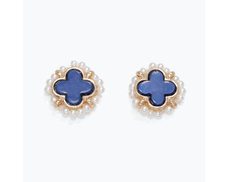 Blue clover-shaped studs with pearl borders and gold trim on white background.
