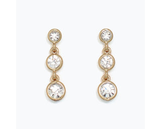 Gold drop earrings with three graduating crystal stones arranged vertically.
