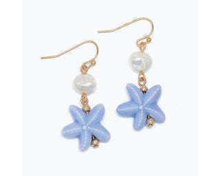 Pair of gold hook earrings with white pearl beads and periwinkle blue starfish charms.
