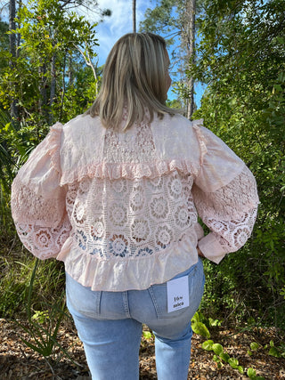 Blush pink lace shacket with puffed sleeves and romantic cutout details, back view.
