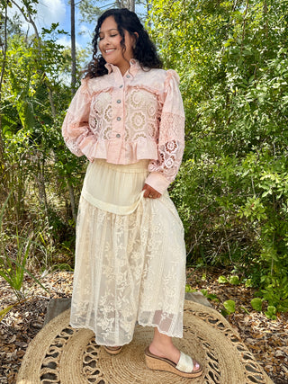 Blush pink lace button-up shacket with ruffled collar and embroidered sleeves.

