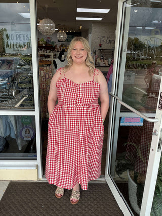 Red gingham tie-shoulder midi dress, perfect for summer outings, with a flattering A-line silhouette and classic checkered pattern.