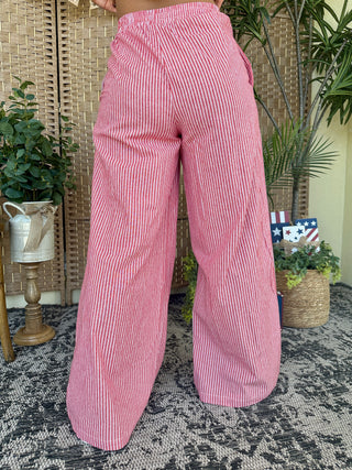 Red and white striped wide-leg pants with elastic waist, relaxed fit.
