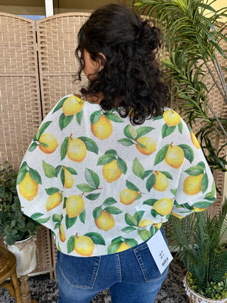White batwing top with yellow lemon and green leaf print pattern.
