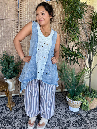 Blue chambray sleeveless tank with white eyelet insert and raw edge hem detail.
