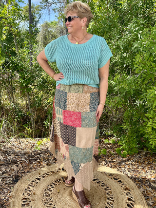 Seafoam crochet short-sleeve top with textured knit pattern and rolled cuffs.
