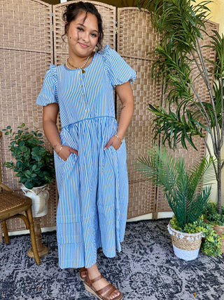 Blue and white vertical striped midi dress with puffed short sleeves and waist tie detail.
