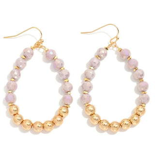 Lavender faceted teardrop earrings with gold bead accents on a stylish background, perfect for elegant fashion.