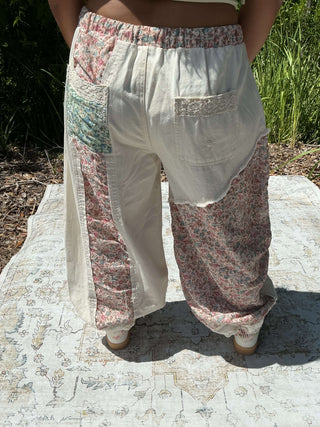 Ivory jogger pants with a floral patchwork design and elastic waistband for a relaxed fit
