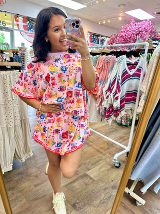 Pink short set with colorful jam jar print, red gingham trim, and ruffled sleeves.
