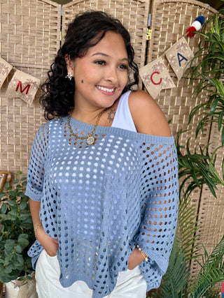 Blue crochet dolman top with eyelet pattern and cold-shoulder neckline.
