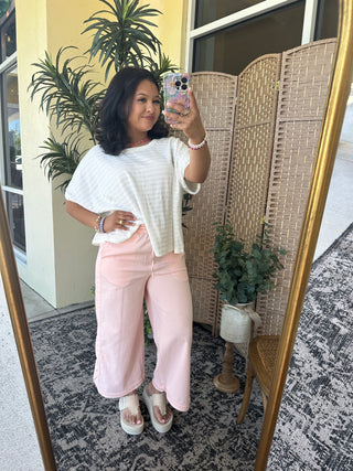 White textured dolman top with short sleeves and relaxed fit.
