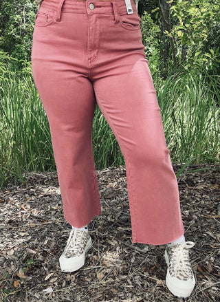 Alt text: "Judy Blue 88983 Dusty Rose Cropped Wide Leg Jeans with high waist and frayed hem laid flat against a white backdrop.