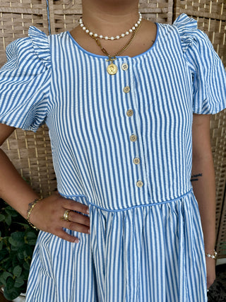 Blue and white vertical striped midi dress with puffed sleeves and button front closure.
