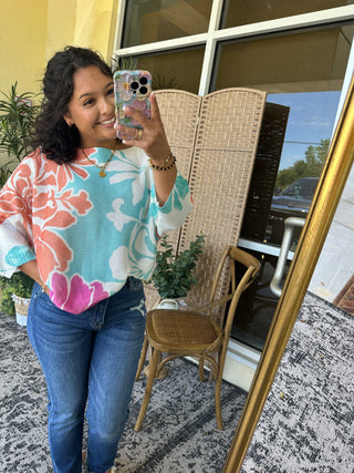 Coral Reef Batwing Top in turquoise, coral, and pink floral pattern with textured knit fabric.

