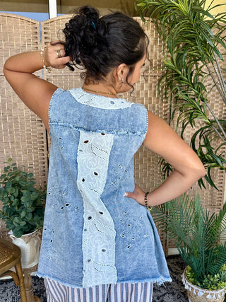 Light blue chambray sleeveless tank top with white eyelet lace center back panel and distressed details.
