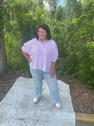 Light blue oversized button-down shirt with ruffle pockets and vertical stripes