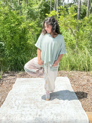 Ivory jogger pants with a floral patchwork design and elastic waistband
