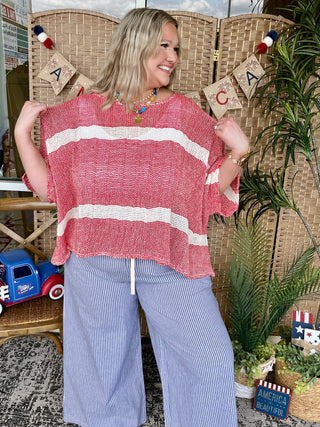 Red and white striped short-sleeve knit top with horizontal color-block stripes.

