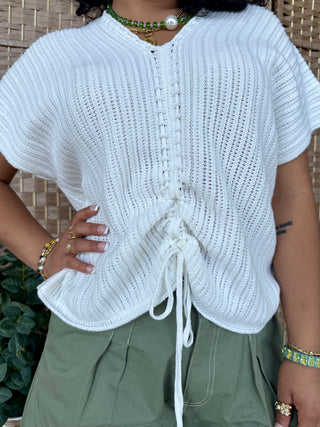 White knit short-sleeve top with drawstring waist and textured crochet pattern.
