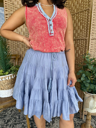 Dusty blue tiered midi skirt with drawstring waist, styled with coral ribbed henley tank top.

