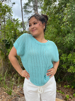 Seafoam crochet short-sleeve top with openwork knit pattern and crew neckline.
