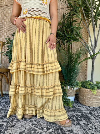 Butter yellow maxi skirt with metallic striped pattern and tiered ruffle hem.
