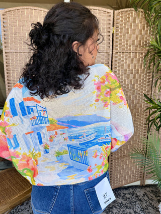 Multicolored batwing top with abstract harbor and geometric print on white mesh fabric.
