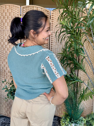 Jade crochet short-sleeve top with white lace stripe detail and distressed side cutout.
