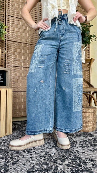 The Wanderer Washed Denim Distressed Wide Leg Pants

