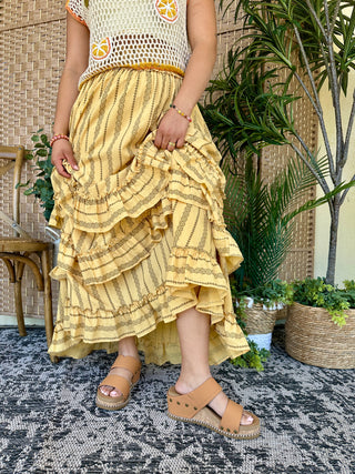 Yellow maxi skirt with olive striped pattern and tiered ruffled layers.
