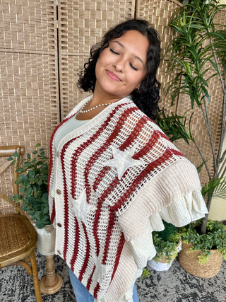 Cream and burgundy striped crochet poncho with fringe trim and short sleeves.
