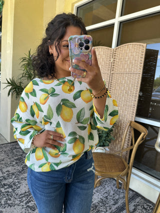 White batwing top with yellow lemon and green leaf print pattern.
