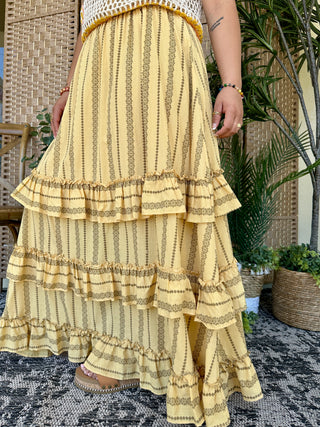 Yellow maxi skirt with gold vertical stripes and tiered ruffle hem detail.
