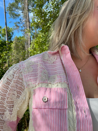 Pink and white striped shacket with cream lace overlay and shell button detail.

