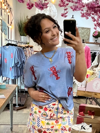 Periwinkle blue t-shirt with red sequin lobster embellishments throughout.
