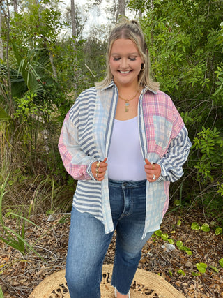 Blue and pink mixed plaid and stripe button-down cardigan over white tank and blue jeans.
