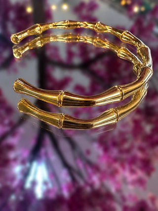 Gold bamboo bangle bracelet with segmented design and polished finish.
