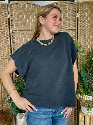 Black oversized drop shoulder t-shirt with short sleeves and relaxed fit.
