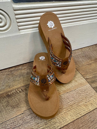 Brown leather thong sandals with beaded turquoise and bronze straps and wedge heel.
