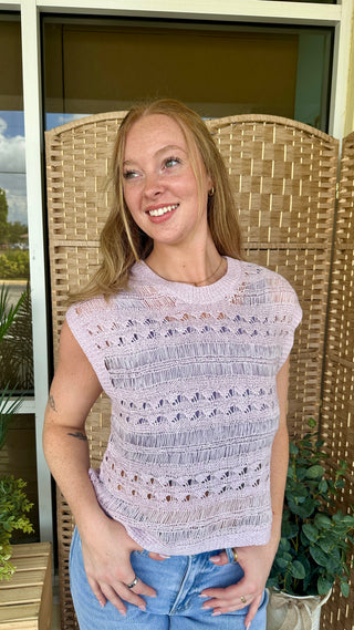 Lavender sleeveless crochet knit top with textured openwork pattern and scalloped stripes.
