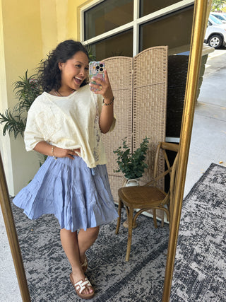 Cream patchwork lace short-sleeve top paired with lavender tiered midi skirt.
