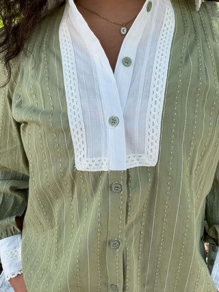 Olive green button-down top with a contrasting collar and long sleeves