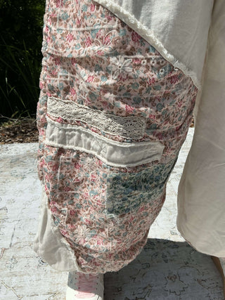 Ivory jogger pants with a floral patchwork design and elastic waistband
