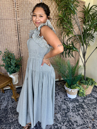 Light blue seersucker midi dress with ruffled neckline and sleeveless design.
